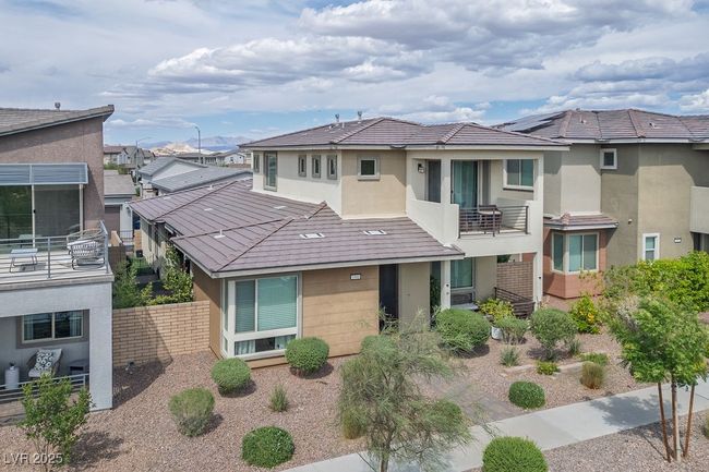 View of front of property with fence, a residential view, a balcony, and stucco siding | Image 7