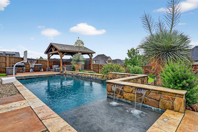 View of swimming pool with a gazebo, a fenced backyard, and a patio | Image 37