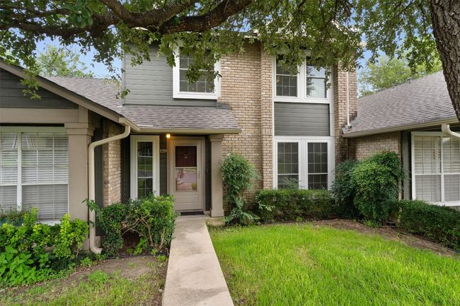 Traditional-style house with roof with shingles, brick siding, and a front yard | Image 4