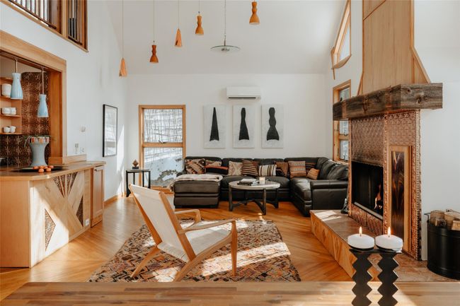Living room featuring a wall mounted air conditioner, light hardwood / wood-style floors, and a high ceiling | Image 8
