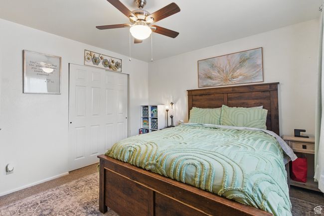 Carpeted bedroom with a ceiling fan, baseboards, and a closet | Image 31