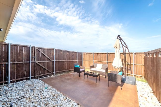 Fenced backyard featuring a patio area, a gate, and outdoor lounge area | Image 34