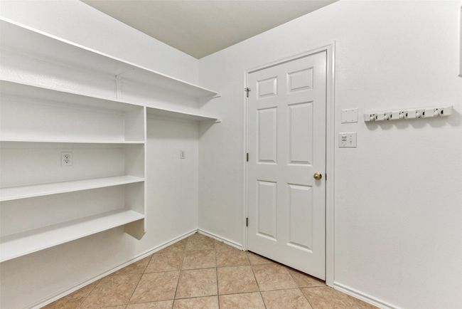 Large laundry room with shelves for storage | Image 12