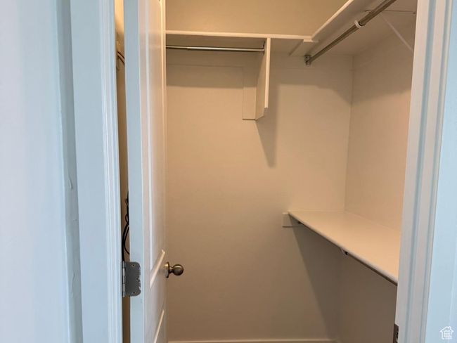 Walk in closet with carpet floors | Image 9