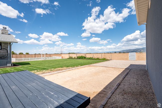 Fenced backyard featuring a patio area and a wooden deck | Image 100