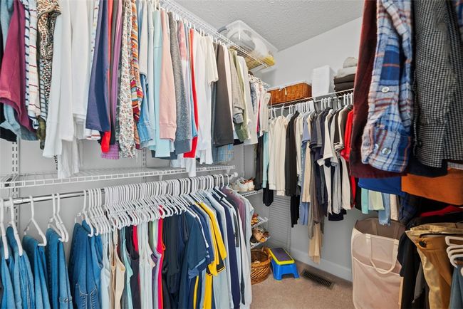 A 9x6 master closet provides space for his and her items. | Image 30