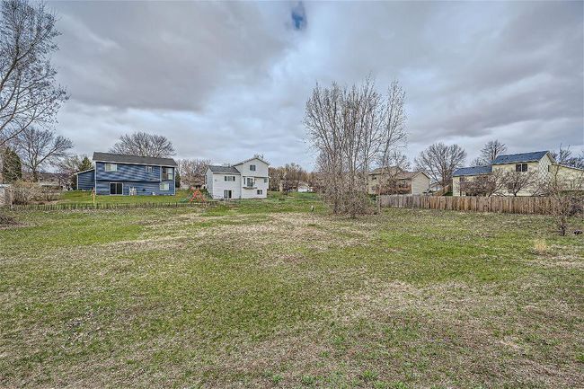 Beyond the fence lies a delightful surprise—a bonus green space that extends beyond the fenced area, offering even more room to roam and enjoy the outdoors! | Image 27