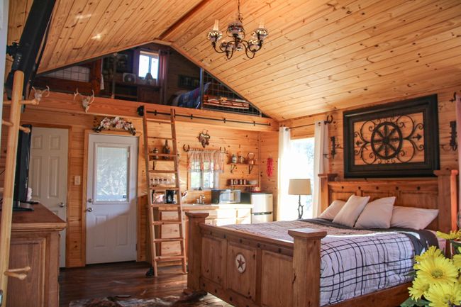 This tiny home is adorable and packed with details. Sleeps 4 comfortably. Complete with full bath (door to the right) and small kitchen. | Image 28