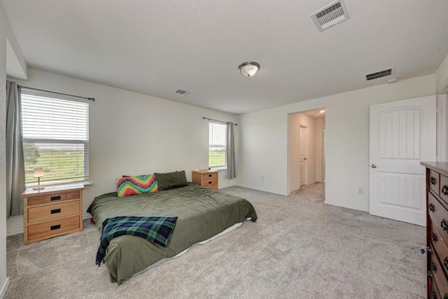 Bedroom featuring light colored carpet and baseboards | Image 24