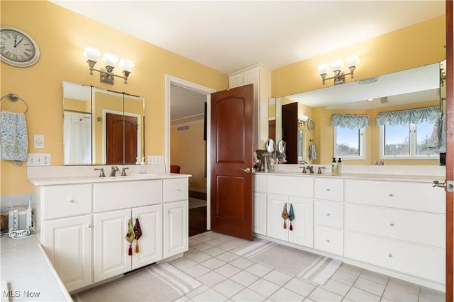 Primary master bathroom with double vanities. | Image 26