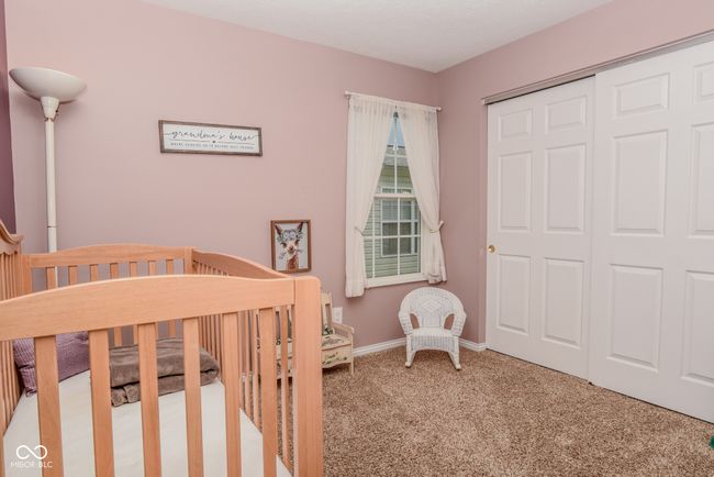 bedroom featuring carpet flooring, baseboards, and a closet | Image 13