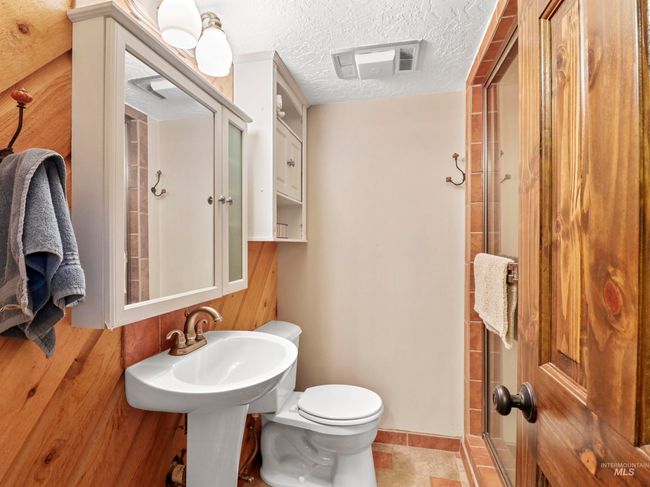 Bathroom with a textured ceiling and a shower | Image 31