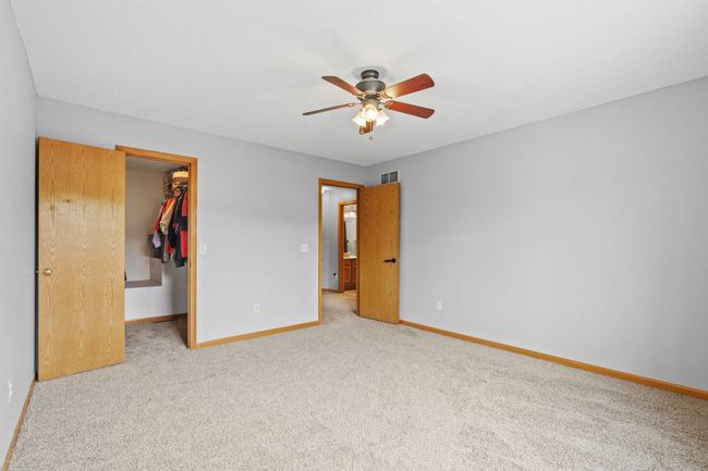 Spacious primary bedroom featuring a walk-in closet and private access to the full bath. | Image 21