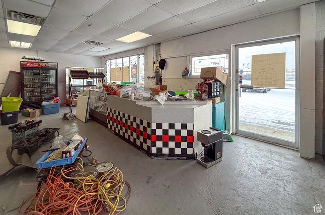 Miscellaneous room featuring a drop ceiling and concrete floors | Image 12