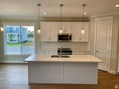 Kitchen featuring appliances with stainless steel finishes, an island with sink, a wealth of natural light, and sink | Image 3