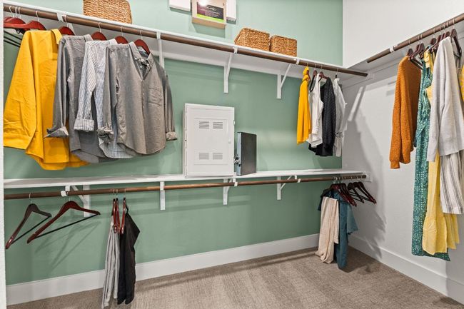 The spacious walk-in closet offers ample storage for clothing, shoes, and accessories. | Image 11