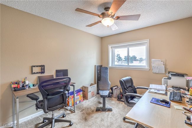 Office with a textured ceiling, carpet floors, and ceiling fan | Image 32