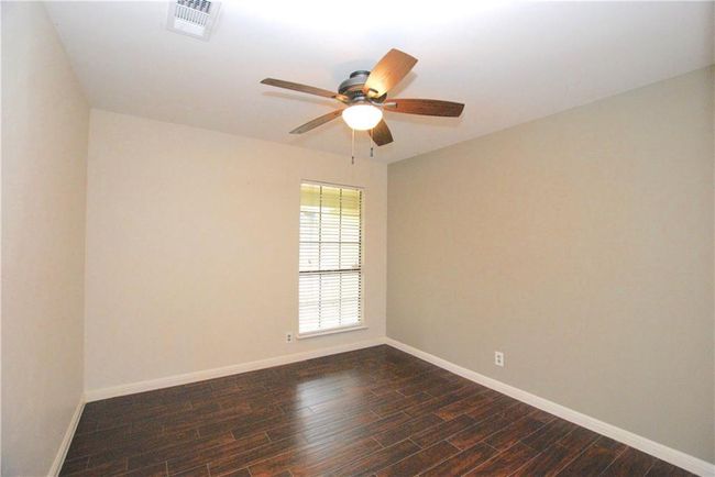 Guest bedroom 1 with a ceiling fan | Image 14
