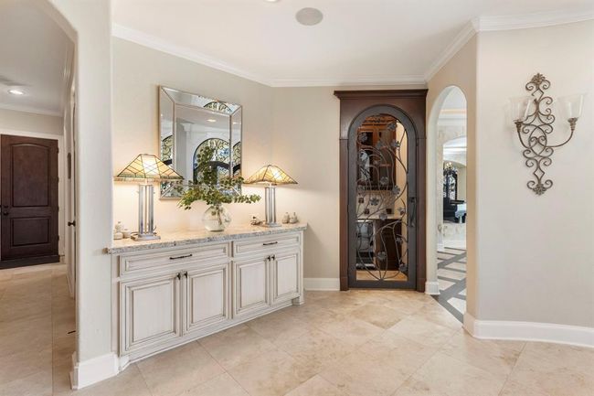 Welcoming Entryway with Elegant Built-In Bar | Image 7