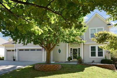 Obstructed view of property featuring a garage and a front lawn | Image 3