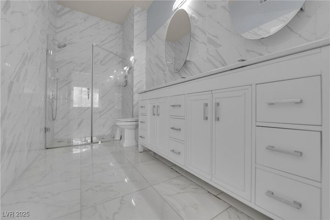 Full bathroom with marble finish floors, a marble finish shower, and vanity | Image 34