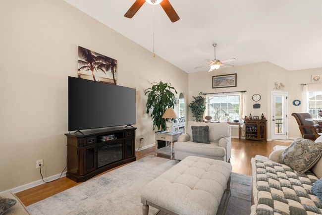 Living area featuring ceiling fan, wood finished floors, and baseboards | Image 7