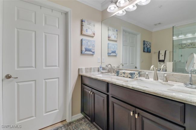 Full bathroom with double vanity, a sink, and crown molding | Image 15