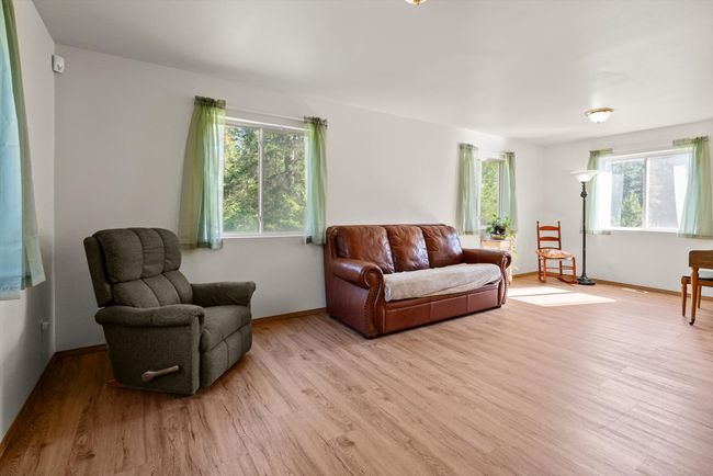 Living area featuring light wood finished floors and baseboards | Image 8