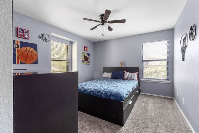 Bedroom with carpet flooring, baseboards, and a ceiling fan | Image 28
