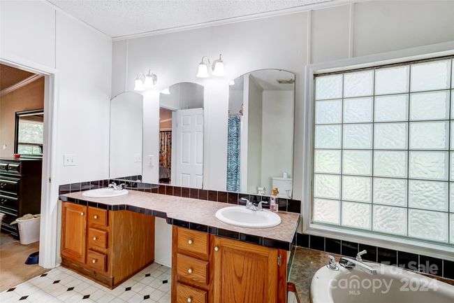 The dual vanity sink includes all the storage space in the primary bathroom you could need! | Image 23