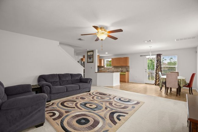 Living area with ceiling fan and baseboards | Image 5