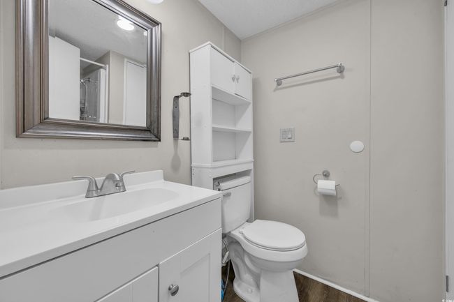 Bathroom with wood finished floors, vanity, and toilet | Image 19