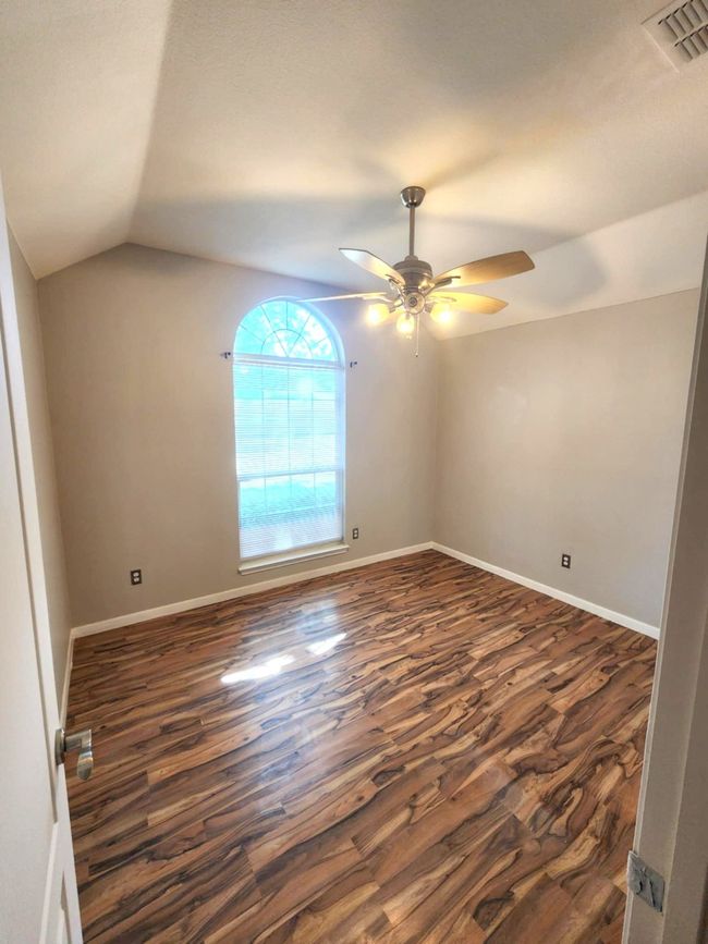 Bathroom with double vanity, wood finished floors, a shower with shower door, and a garden tub | Image 17