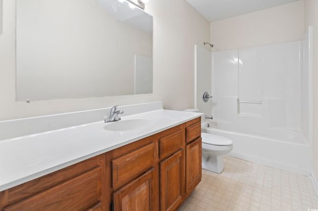 Bathroom featuring vanity, toilet, shower / tub combination, and tile patterned floors | Image 27