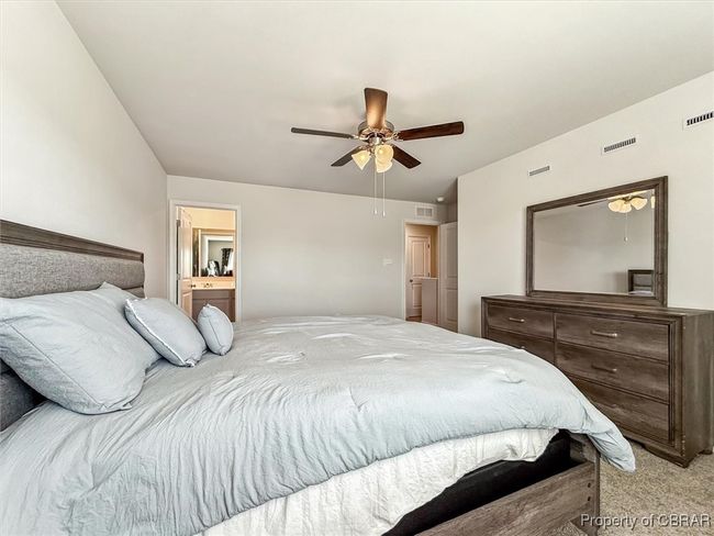 Bedroom featuring light colored carpet, ceiling fan, and visible vents | Image 17