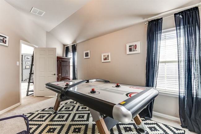 Game room with light carpet, plenty of natural light, and vaulted ceiling | Image 38
