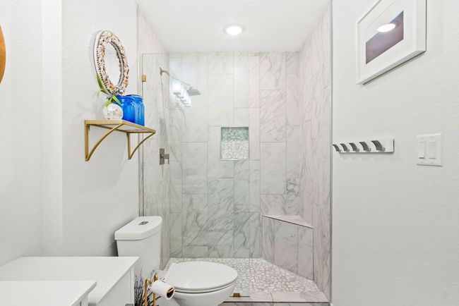 Primary Shower with tile and pebblestoned floor | Image 22