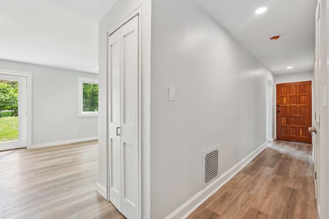 Hallway light & bright natural light, light wood-style flooring, and recessed lighting | Image 10
