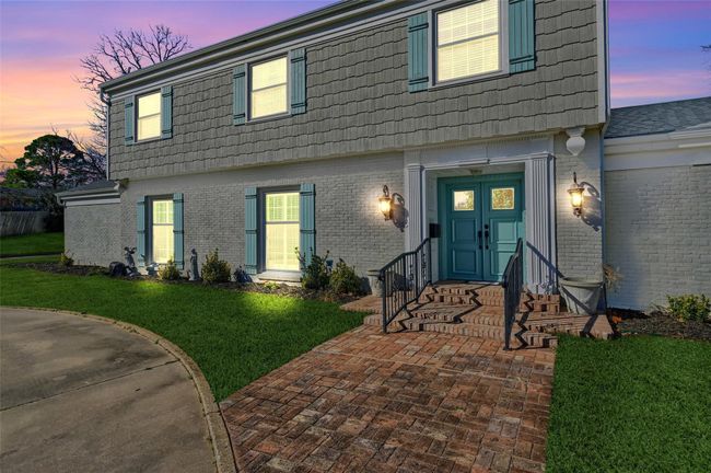 View of front facade with brick siding, a yard, mansard roof, and entry steps | Image 4