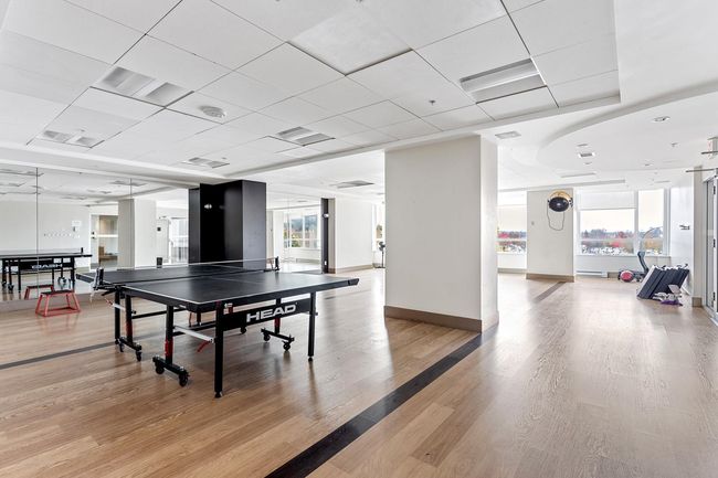 Playroom featuring light wood-style flooring, baseboards, and a drop ceiling | Image 20