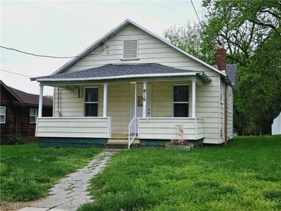 Bungalow with a front lawn and a porch | Image 1