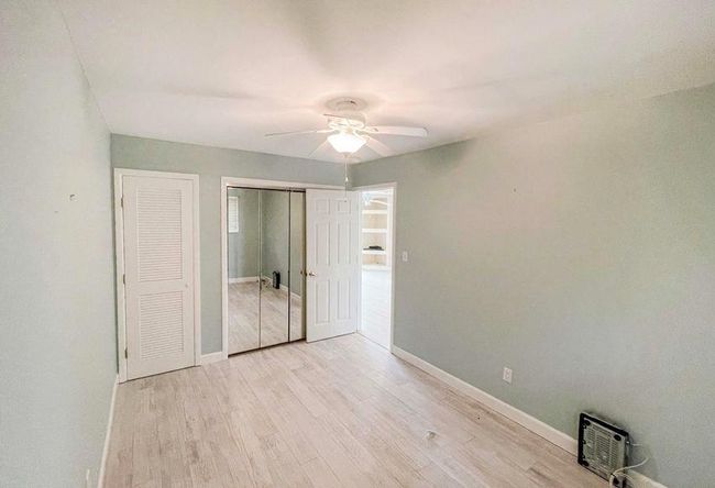Unfurnished bedroom with baseboards, light wood finished floors, and ceiling fan | Image 18