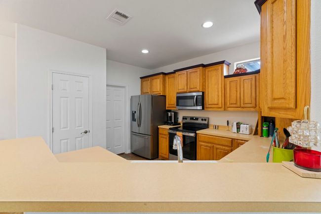 Stainless steel appliances and upgraded fridge ready to help you knock out weeknight dinners or host a crowd. | Image 14