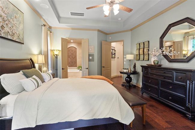 Tall ceilings and doorways make this home feel even larger than it is. Primary bedroom features surround sound, tray ceilings and more engineered hardwood flooring. | Image 16
