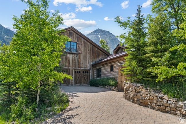 View of front of property with a garage, decorative driveway, and a mountain view | Image 64