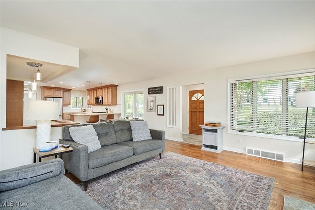 Living room with healthy amount of natural light, light wood-style floors, baseboards, and recessed lighting | Image 10
