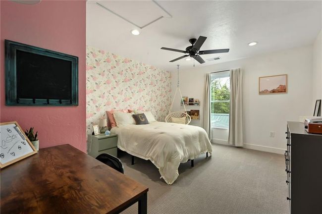 Bedroom with attic access, carpet flooring, and a wallpaper accent wall | Image 41