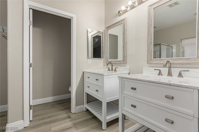 Master Bathroom featuring 2 sinks, two vanities & wood finished floors. | Image 21