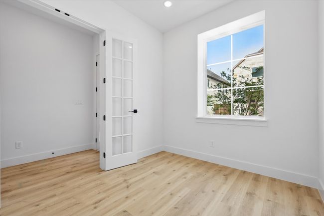 Spare room with healthy amount of natural light, baseboards, wood finished floors, and recessed lighting | Image 5