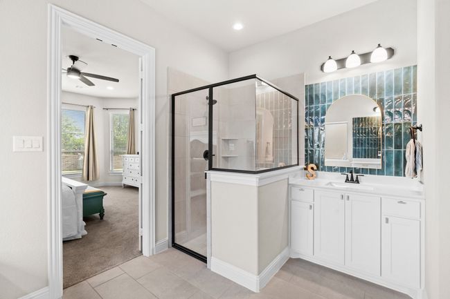 Bathroom featuring ceiling fan, a shower stall, vanity, and tile patterned floors | Image 25